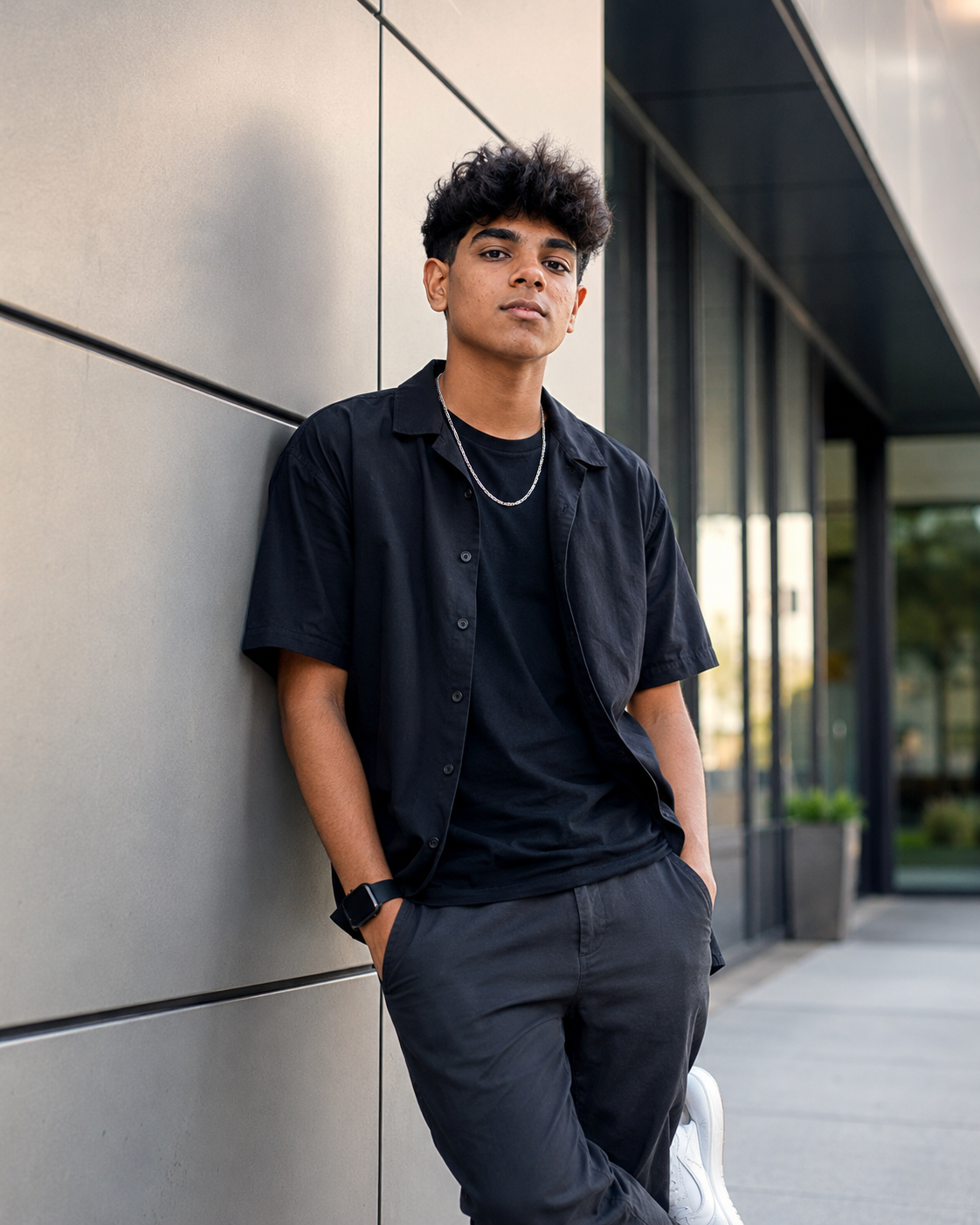 Akshath Saravanan standing in a modern architectural setting.